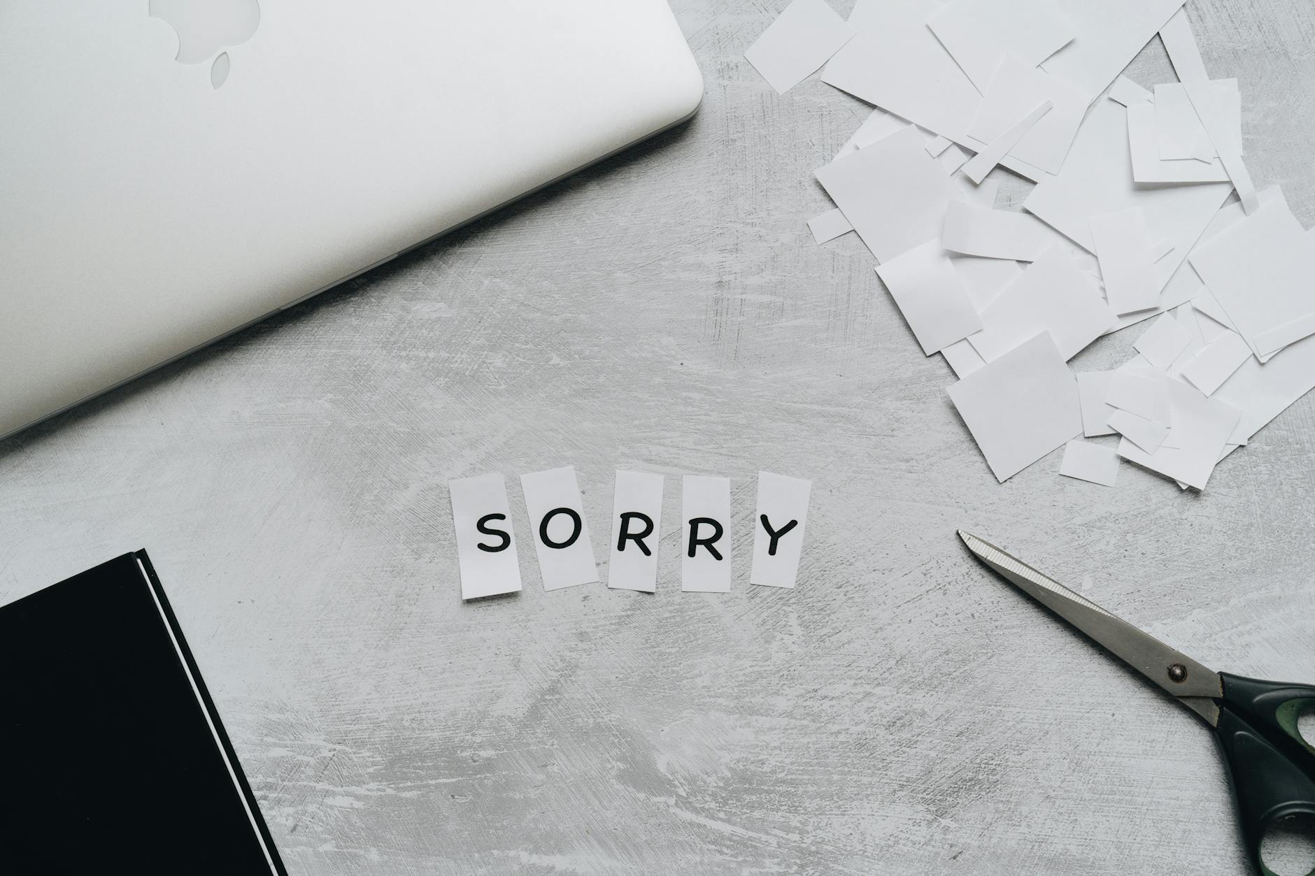 sorry text in pieces of white paper